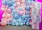 Photo zone for a gender party made of cubes and pink and blue balloons