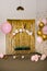 Photo zone for a girl`s birthday party. Cinderella or princess carriage and pink gold balloons
