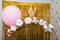 Photo zone for a little Princess: a carriage and balloons on a Golden shiny background. Decor for a child`s birthday