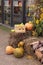 Photo zone near a cafe or shop for Halloween. Pumpkins, straw. Vertical Orientation