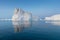 Photogenic and intricate iceberg under an interesting and blue sky during sunset. Effect of global warming in nature.