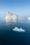 Photogenic and intricate iceberg under an interesting and blue sky during sunset. Effect of global warming in nature.