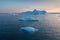 Photogenic and intricate iceberg under an interesting and blue sky during sunset. Effect of global warming in nature.