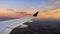 Photograph of an airplane with its commercial wide-body wing ascending to the height of the cruising clouds.