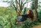 Photograph of a beautiful girl riding a swing in a blue dress over a canyon