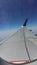 Photograph blue sky cloud taken from inside the plane.