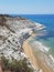 Photograph of the chalk cliffs licked by the waves of the Mediterranean sea against the pristine blue sky the Sicilian coast