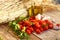 Photograph of Cherry tomatoes with garlics and olive oil on rustic background.