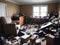 Photograph of a cluttered living space filled with trash debris broken furniture