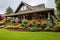 photograph of a craftsman house featuring overhanging eaves and a green garden