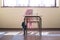 Photograph of a desk and chair in a primary classroom where you can see the typical material of a child student.The photo is shot