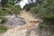 Photograph of a dirt walking track affected by severe rain and flooding