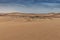 Photograph of dunes with vegetation of the Namibe Desert. Africa. Angola