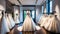 Photograph of elegant wedding dresses hanging on hangers in a luxury store, wedding dress in the showroom of a bridal boutique