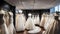 Photograph of elegant wedding dresses hanging on hangers in a luxury store, wedding dress in the showroom of a bridal boutique