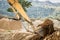 A photograph of the heavy machinery at the quarry, rocks and sand conveyor belt.