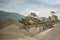 A photograph of the heavy machinery at the quarry, rocks and sand conveyor belt.