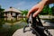 Photograph male hand handling an old vintage camera on tripod in front of water pond with landmark japanese house and