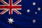Photograph of the national flag of Australia on a luxurious texture of satin, silk with waves, folds and highlights, closeup, copy