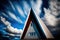 Photograph of the pointed gabled roof of a modern design of a house, in Nordic triangular style, with blue sky