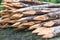 Photograph of pointed wood logs stacked and prepared for farm closings.The photo is in horizontal format