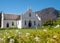 Photograph of the restored whitewashed, gabled Dutch Reformed Church in the main street in Franschhoek, South Africa