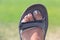 Photograph of sparkly pedicure toes on a left foot wearing a sandal during the summer