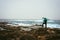 Photograph with tripod searching for good motive. Waves hitting volcanic rocky coastline. Santo Antao Island, Cape Verde