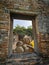 A Photograph of window view of statue of Reclining Buddha