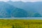 Photograph of winter season: A colourful lake, mountain, clear sky and farm land. Wide angle landscape of Pokhara Lake at Kathmand