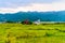 Photograph of winter season: A farm house, lake, mountain, clear sky and farm land. Wide angle landscape of Pokhara Lake at Kathma