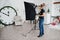 Photographer adjusts the flash light on studio