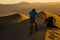 Photographer being blown by wind is framing their shot in Death Valley National Park