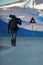 Photographer with big lens and road traffic sign with Polar bear. Man on the road with snowy mountain, travel in Svalbard in Norwa