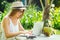 Photographer blonde female working outdoor retoucher and drinking coconut