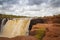 Photographer with camera and tripod photographing the King George Falls.