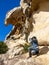 Photographer Capturing Sunlit Rock Formation Outdoors. Copyspace