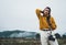 Photographer girl hold in hands mobile typing message on smartphone on background landscape autumn froggy mountain, tourist shoot