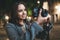 Photographer girl with retro camera take photo on background bokeh light in evening city, smile blogger enjoy photoshoot photo