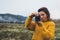 Photographer girl take photo on camera closeup on background autumn mist mountain, tourist shooting nature landscape, hobby