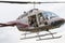 Photographer in Helicopter with unhinged doors and long lens