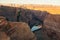 Photographer on Horseshoe Bend in Glen Canyon National Recreation Area in early dawn