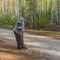 Photographer making photo with old film camera in morning birch forest