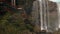 Photographer making the photo in a waterfall in the forest