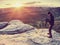 Photographer on mountain cliff take picture of landscape awaking