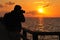 Photographer and ocean sunset