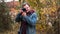 Photographer photographing in autumn forest. Travel and hobbie concept. day