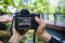 A photographer is photographing the bridge. He is holding the camera