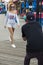 Photographer photographs a fashion model girl in Coney Island Beach, New York City, USA