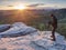 Photographer prepare equipment for taking photos on summit